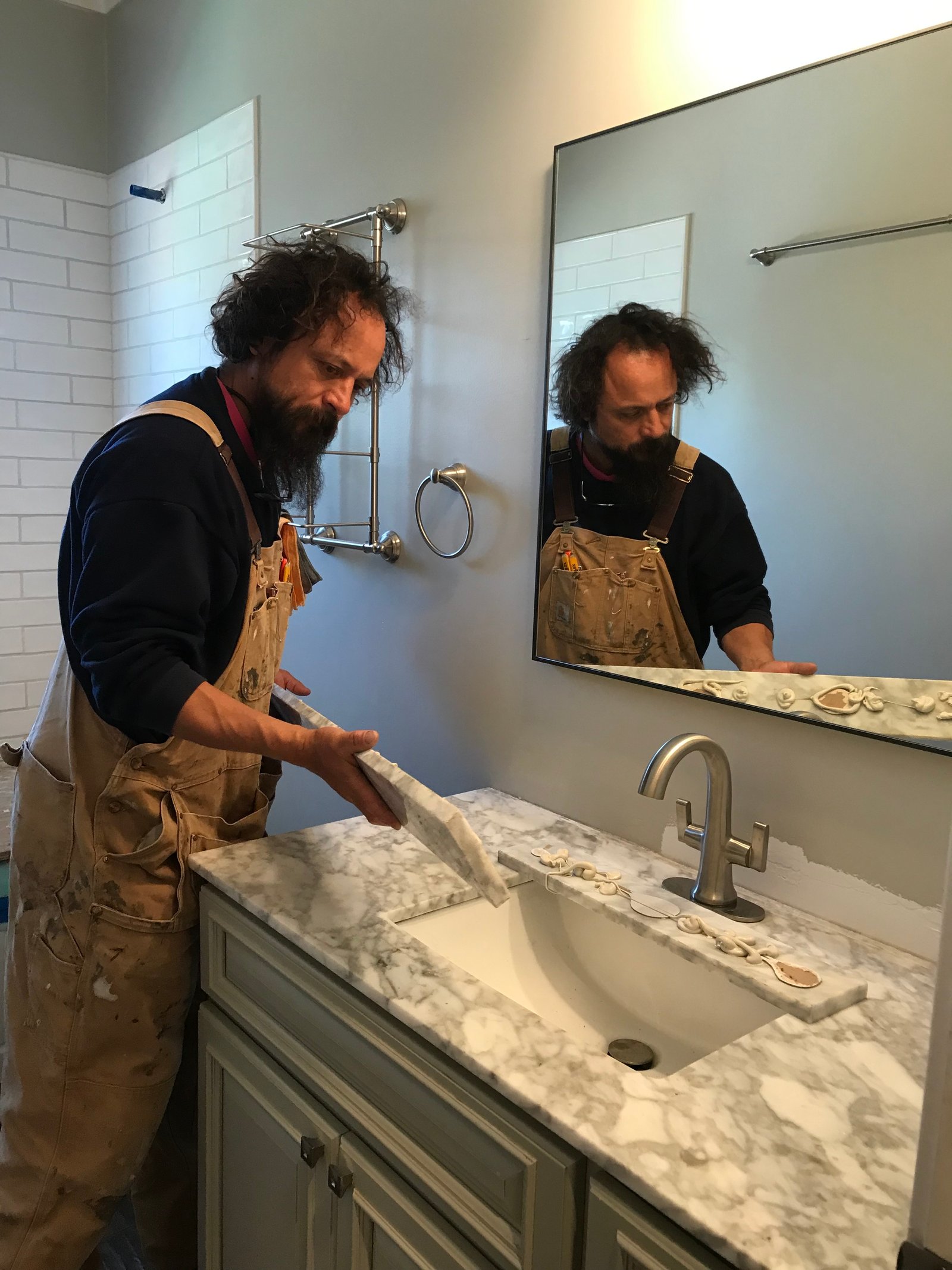 Installer dry fitting marble trim along the vanity top